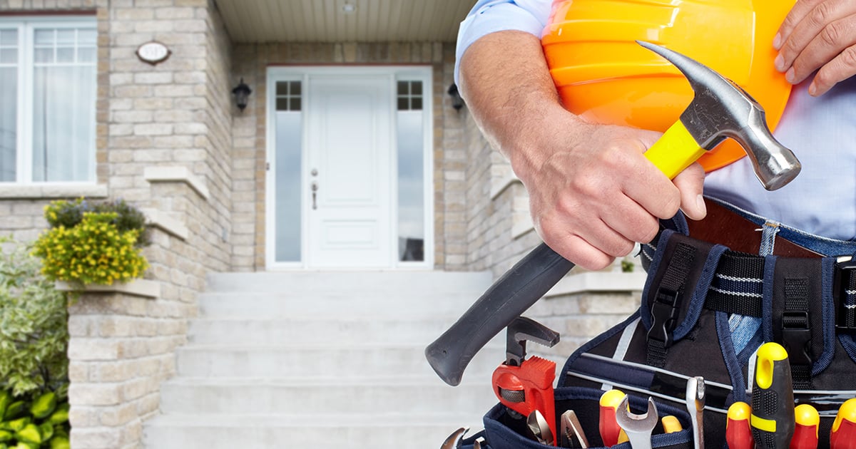 Contractor stands in front of home renovation project