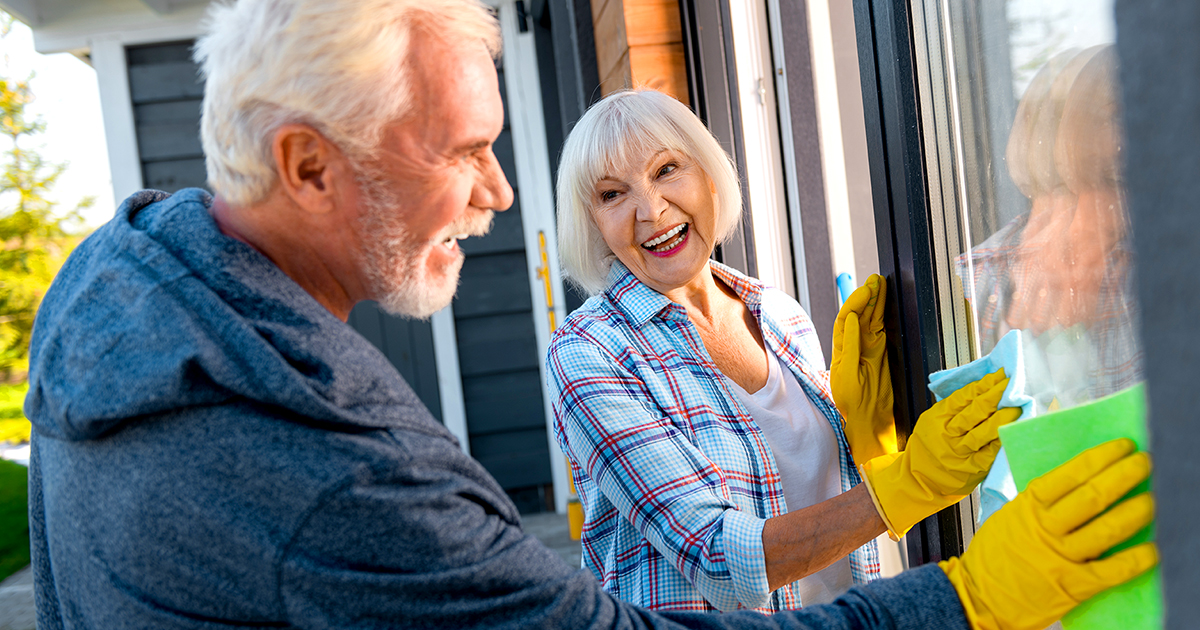 Couple works together to clean windows