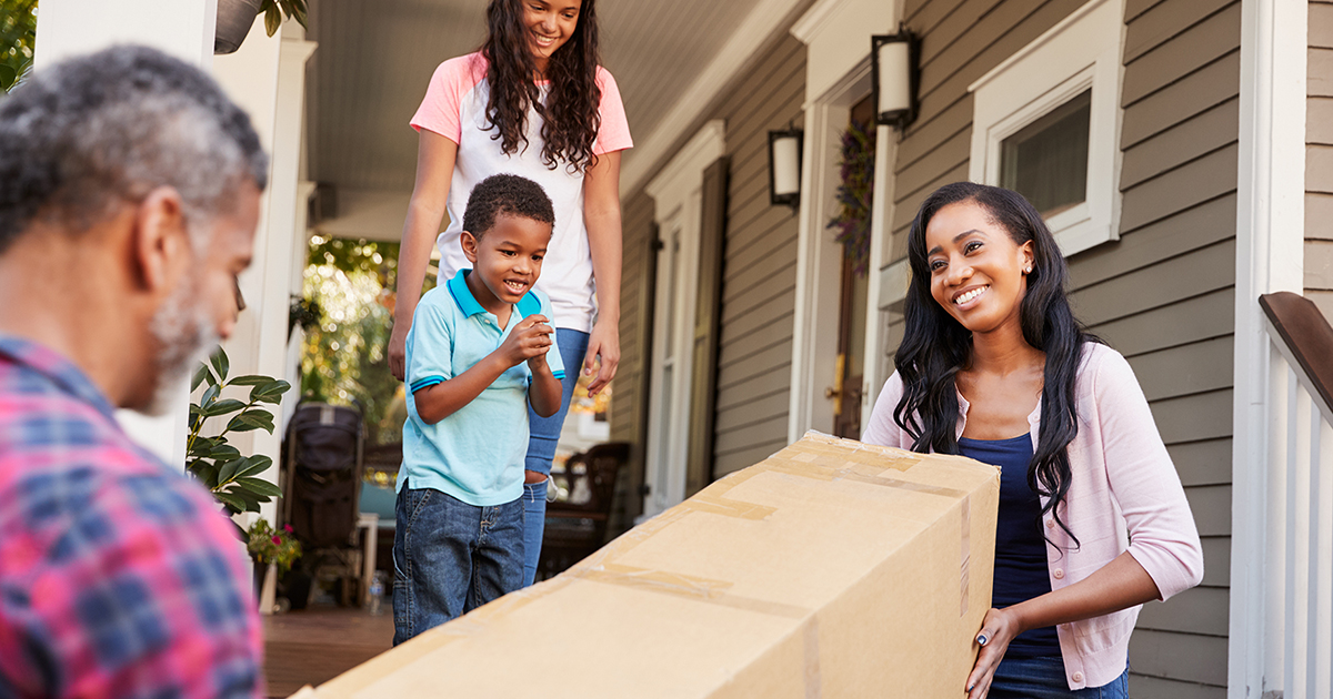 Family carries boxes during a move