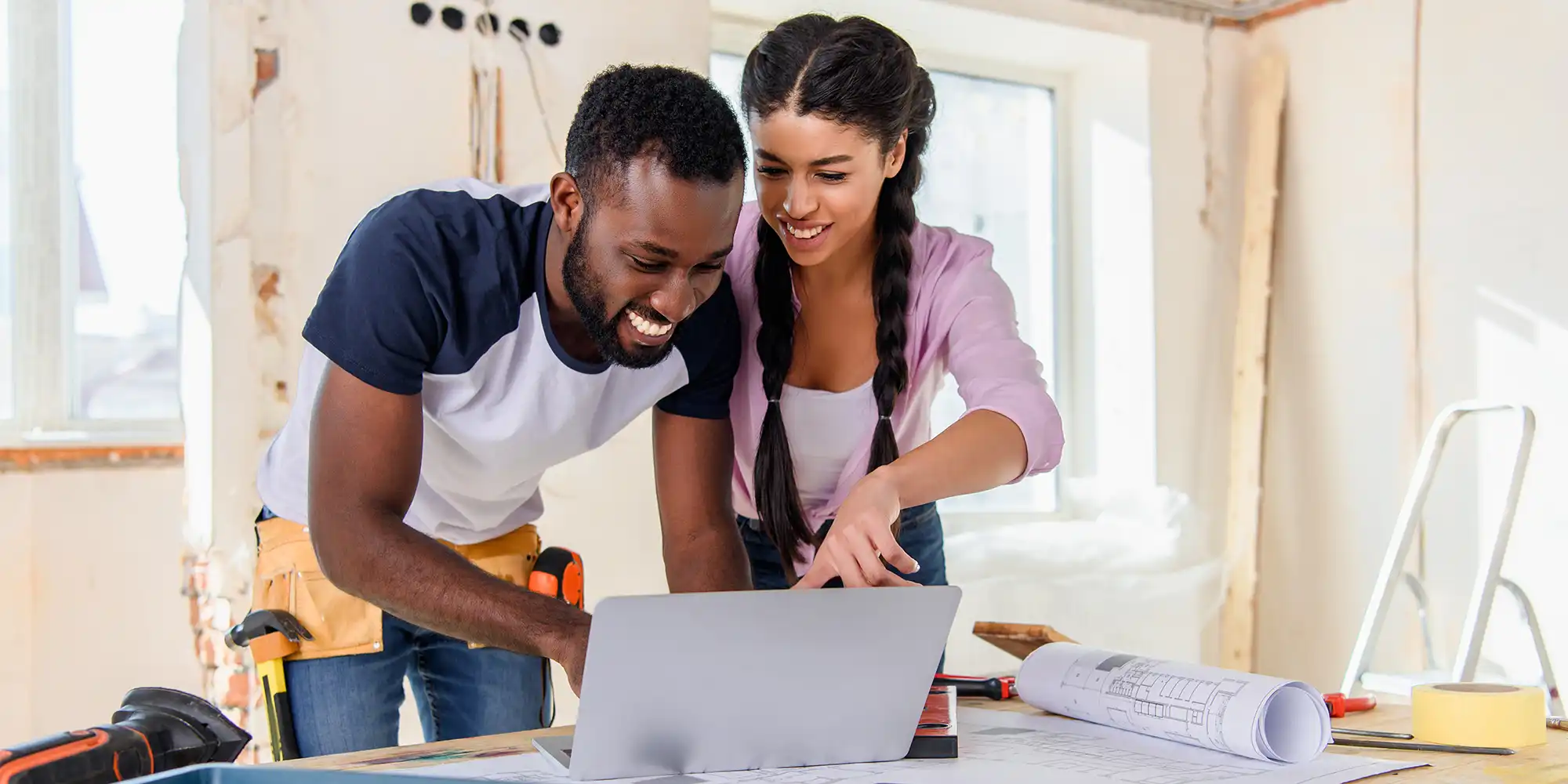 young BIPOC couple renovating their home together happily