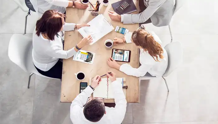 aerial view of team working together at a table700px