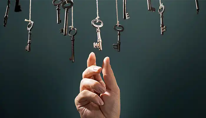 hand reaching up to select key hanging amongst many keys