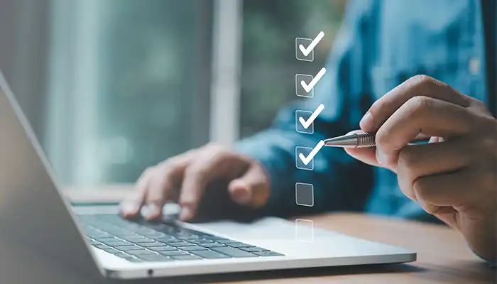 laptop with checkmark illustration above it