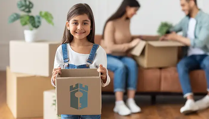 young girl holding moving box with ccm logo700px