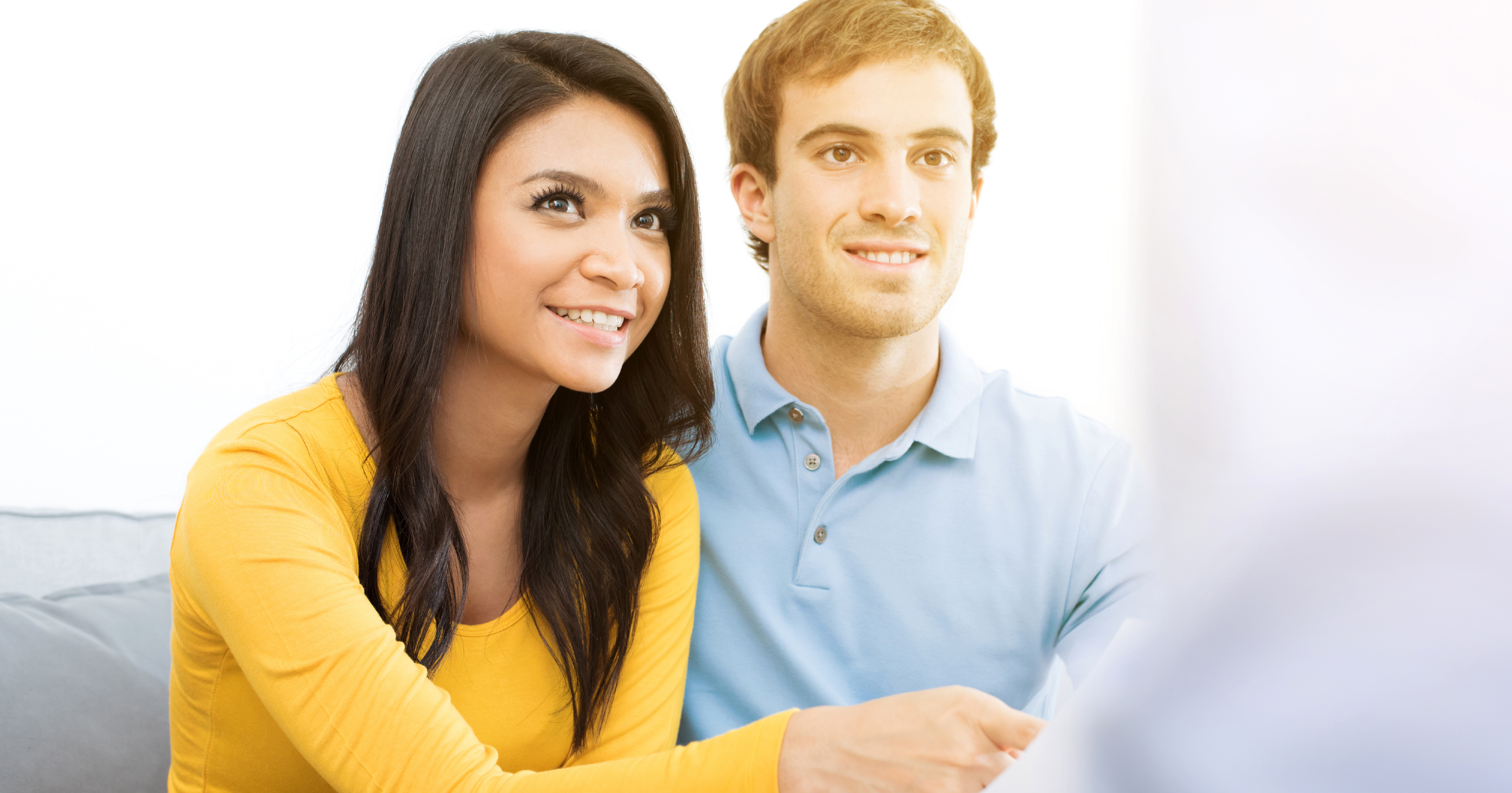 Happy couple considers down payment assistance options