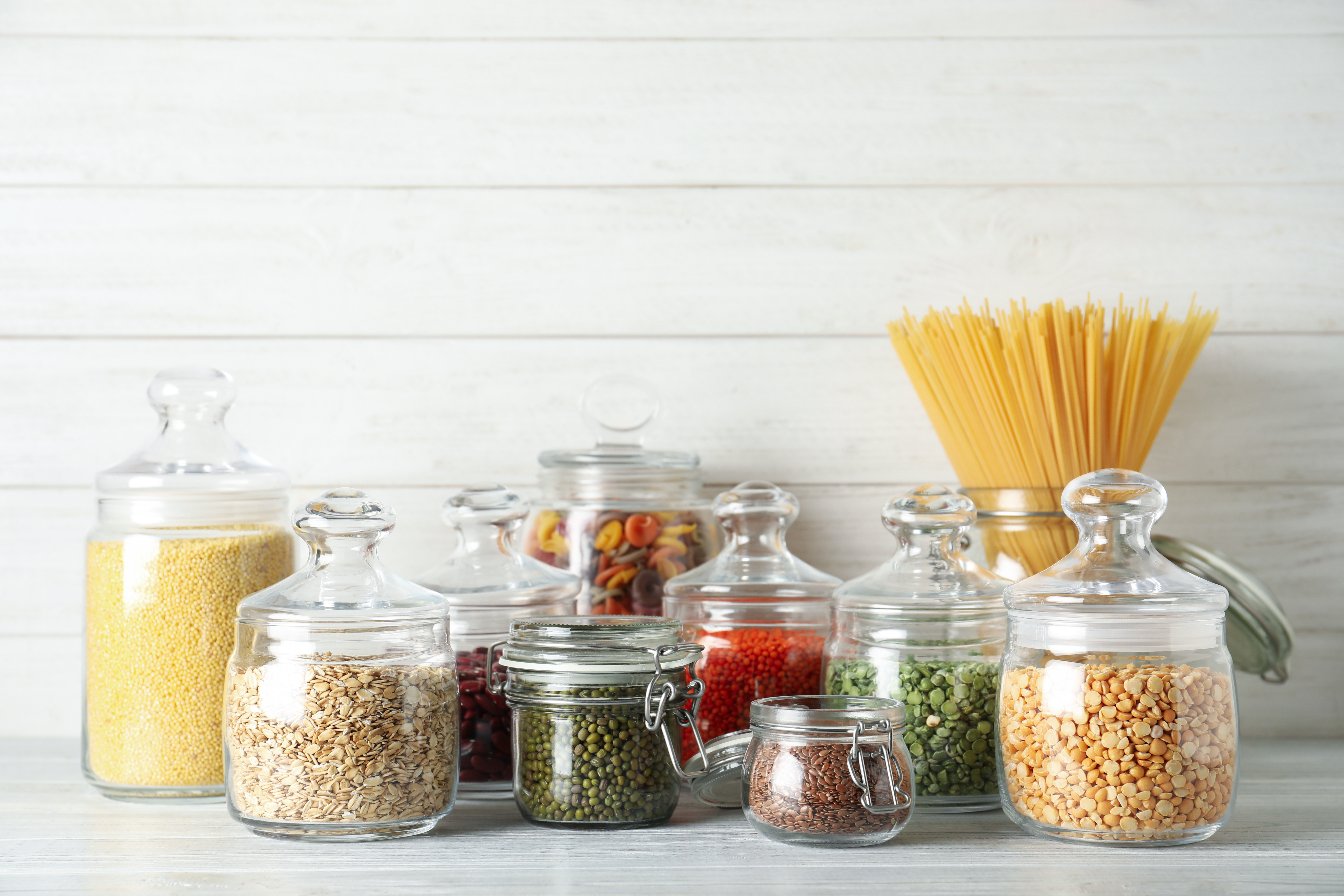 Food in glass jars on pantry shelf